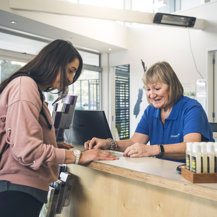 A passenger talks to a staff member at the Cougar Line office and information desk in Picton at the Marlborough Sounds, New Zealand.